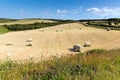 Cornwall country scene with hay bales like cotton reels on a beautiful sunny summer day Royalty Free Stock Photo