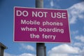Mobile phones banned when boarding ferry sign.