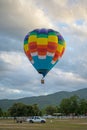 Coroful Hot Air Ballon Flying In The sky with clouds and mountain background Royalty Free Stock Photo