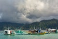 Tourist boats with tourists by the beach of a small island in the sea. Coron, Philippines