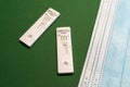 Corona antigen rapid test and masks on green background Royalty Free Stock Photo