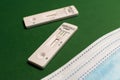 Corona antigen rapid test and masks on green background, close up Royalty Free Stock Photo