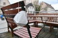 Corona crisis - lockdown - FFP2 mask hangs on a chair in an empty beer garden in Steyr, Austria, Europe