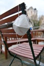 Corona crisis - lockdown - FFP2 mask hangs on a chair in an empty beer garden in Steyr, Austria, Europe