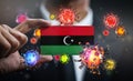 Corona Virus Around Libya Flag. Concept Pandemic Outbreak in Country