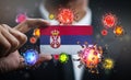 Corona Virus Around Serbia Flag. Concept Pandemic Outbreak in Country