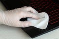 Corona virus cleaning and disinfection of your workspace. Woman wipes a computer keyboard with a sanitizer to protect Royalty Free Stock Photo