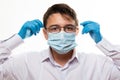 Corona virus covid-19 : Closeup with the face of a young doctor with glasses and wearing medical or surgical mask