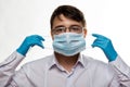 Corona virus covid-19 : Closeup with the face of a young doctor with glasses and wearing medical or surgical mask