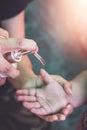 Corona virus or COVID-19 pandemic prevention, Mother put hand sanitizer to her daughter hand. wash hands with Alcohol based hand Royalty Free Stock Photo