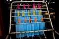 Corona Virus pandemic masks being hanged on a cloth rod after cleaning. Reusable blue colored face masks