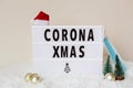 Corona Xmas concept. Merry Christmas during coronavirus covid-19 pandemic quarantine. Text, accessories and face mask on