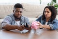 Coronacrisis Concept. Desperate African Couple Counting Last Money At Home Royalty Free Stock Photo