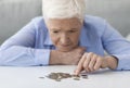 Coronacrisis And Financial Problems. Senior Woman Counting Remaining Coins, Suffering From Poverty