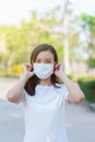 Coronavirus and Air pollution pm2.5 concept.Asian woman wearing medical face mask. Woman Wearing Protective Mask. Woman wearing