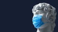 Coronavirus. Ancient Greek plaster head in a medical mask, place for text. European pandemic. sculpture in a protective mask is a