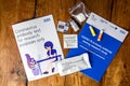 Thame,UK 30/10/20: Coronavirus antibody test set with introduction and instruction books on rustic wooden table, provided randomly