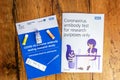 Thame,UK 30/10/20: Coronavirus antibody test set with introduction and instruction books on rustic wooden table, provided randomly