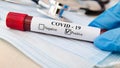 Coronavirus Blood Test Concept. Doctor Hand In Medical Glove Holding Test Tube With Coronavirus Positive Blood