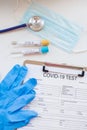 Coronavirus blood test concept. Laboratory table with medical form Coronavirus test, respiratory mask, stethoscope