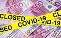 Coronavirus and business concept, caution tape on euro money stack, world economy hits by corona virus outbreak Royalty Free Stock Photo