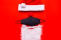 Coronavirus Christmas. Santa Claus Hat red nose Face Mask white beard.Flat lay top view Royalty Free Stock Photo