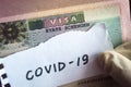 Coronavirus concept. Note COVID-19 coronavirus and Schengen visa in passport. Border control and quarantine of tourists infected