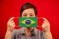 Coronavirus COVID-19 in Brazil. Woman in medical protective mask with the image of the Brazilian flag