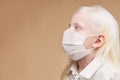 Coronavirus, covid-19 concept. albino child in medical mask isolated