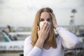 Coronavirus covid-19 epidemic fear concept. beautiful caucasian passenger girl in a respiratory medical mask looking at