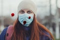 Coronavirus, covid19. Frightened young girl in a medical mask on the street and coronavirus microb cell against viruses Royalty Free Stock Photo