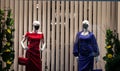 Selective blur on two fashion dummies in a closed clothing fashion retailer store wearing respiratory face mask covering