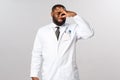 Coronavirus, covid19 and healthcare concept. Gross what that smell. Disgusted african-american male doctor shut nose and