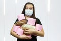 Coronavirus COVID-19 hysteria with toilet paper. Woman in a protective mask. Concept on the topic coronavirus, isolated