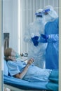 Coronavirus covid-19 infected caucasian senior patient under doctor and medical team examine and make virus treatment in hospital