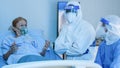 Coronavirus covid-19 infected caucasian senior patient under doctor and medical team examine and make virus treatment in hospital