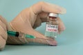 Coronavirus COVID-19 injection in doctor`s hands, small bottle of ampoule