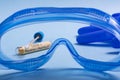 Coronavirus covid-19 nasal swab test seen through PPE glasses