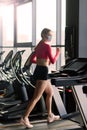 Coronavirus covid-19 prevention, fitness girl with a medical mask posing in gym. Fighting viruses Royalty Free Stock Photo