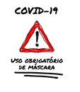 Coronavirus Covid-19 public poster with a red warning triangle and the text in portugese `Uso obrigatÃÂ³rio de mÃÂ¡scara`