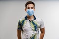 Coronavirus covid-19 quarantine concept. Man in blue medical mask is sick covid virus isolated on white background. Royalty Free Stock Photo