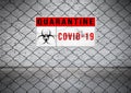 Coronavirus covid 19 quarantine and outbreak alert sign on Wire fence. Old white brick wall background Royalty Free Stock Photo