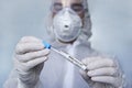 Coronavirus Covid-19 respiratory sputum specimen swab test tube with gloves, mask. specialist in a protective suit examines the