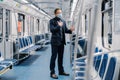 Coronavirus, Covid-19. Sick man feels unwell, has shortage of breathing, wears medical mask, poses in subway carriage, protects Royalty Free Stock Photo