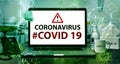 Coronavirus or Covid-19 text on laptop background concept. Mockup deskphone with facial masks and Alcohol Hand Sanitizer on worki