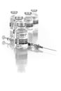 Coronavirus COVID-19 Vaccine Vials and Syringe On Reflective Surface Royalty Free Stock Photo