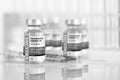 Coronavirus COVID-19 Vaccine Vials and Syringe On Reflective Surface Royalty Free Stock Photo