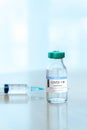 Coronavirus COVID-19 Vaccine Vials and Syringe On Reflective Surface Royalty Free Stock Photo