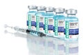 Coronavirus COVID-19 Vaccine Vials and Syringe On Reflective Surface Royalty Free Stock Photo