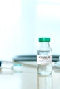 Coronavirus COVID-19 Vaccine Vials and Syringe On Reflective Surface Royalty Free Stock Photo